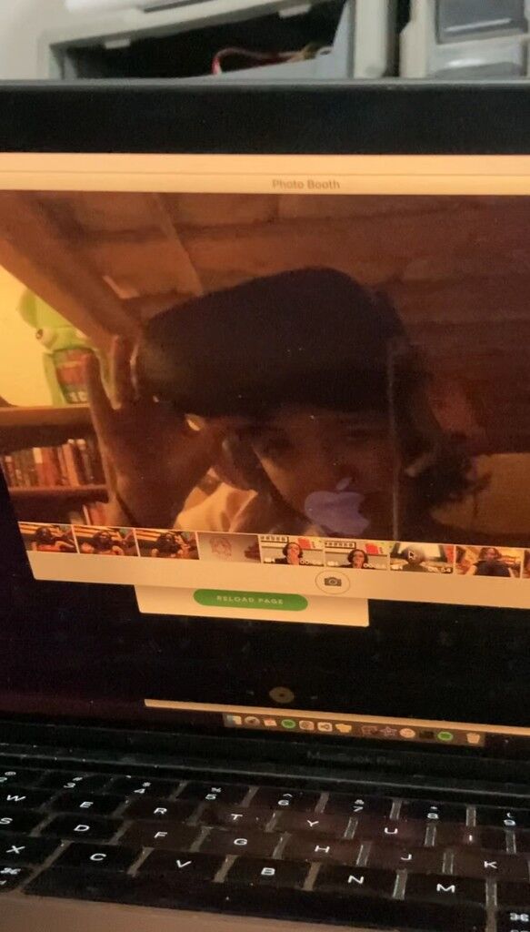 A laptop screen showing Photo Booth, a headset on in the picture